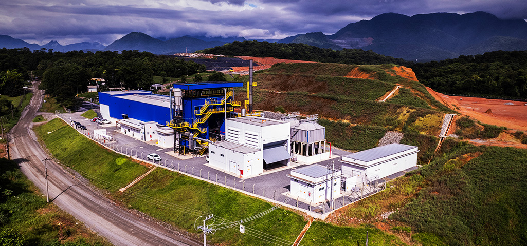 Fábrica de energia sustentável em uma área de floresta e montanhas, destacando a produção de energia limpa na região rural.